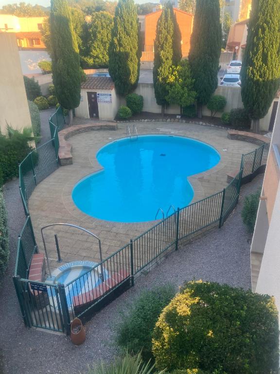 Elle offre une vue sur la piscine entourée d'une clôture. dans l'établissement argeles sur mer, à Argelès-sur-Mer