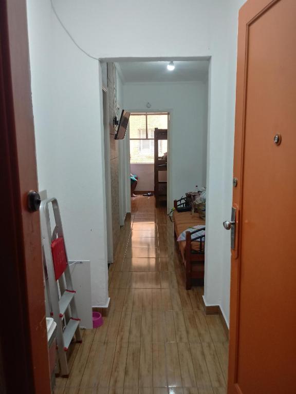 a hallway leading to a living room with a wooden floor at APMartinsjreige in São Vicente