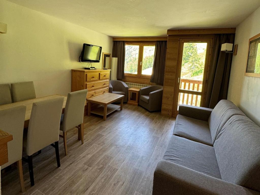 un salon avec un canapé et une table dans l'établissement Appartement spacieux au pied des pistes avec piscine, sauna et balcon, Belle Plagne. - FR-1-181-2812, à La Plagne Tarentaise