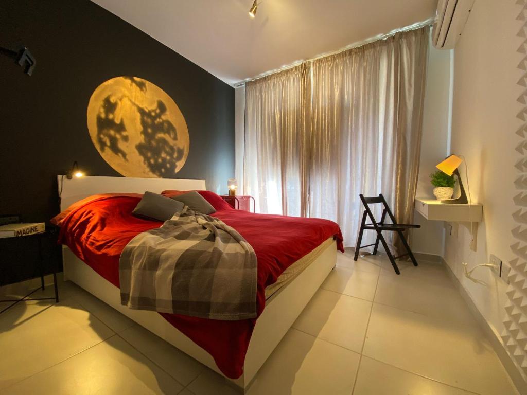 a bedroom with a large bed and a window at New Stylish Design Apartment in St Julian's