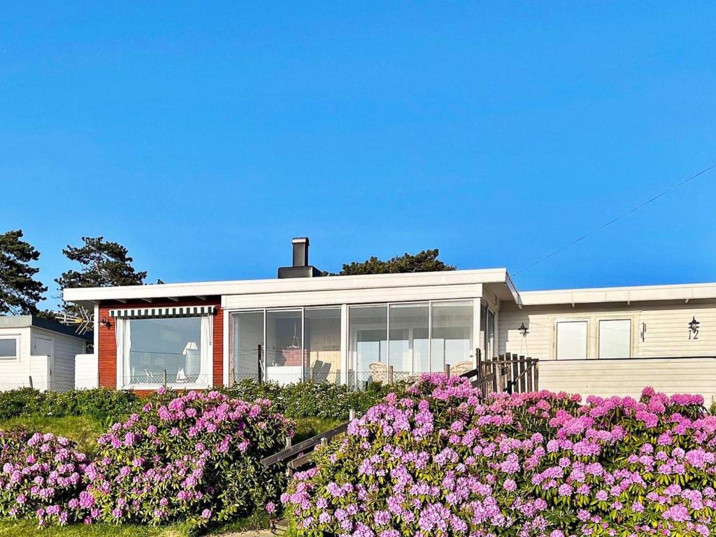 a house with pink flowers in front of it at 9 person holiday home in Skummeslövsstrand in Skummeslövsstrand