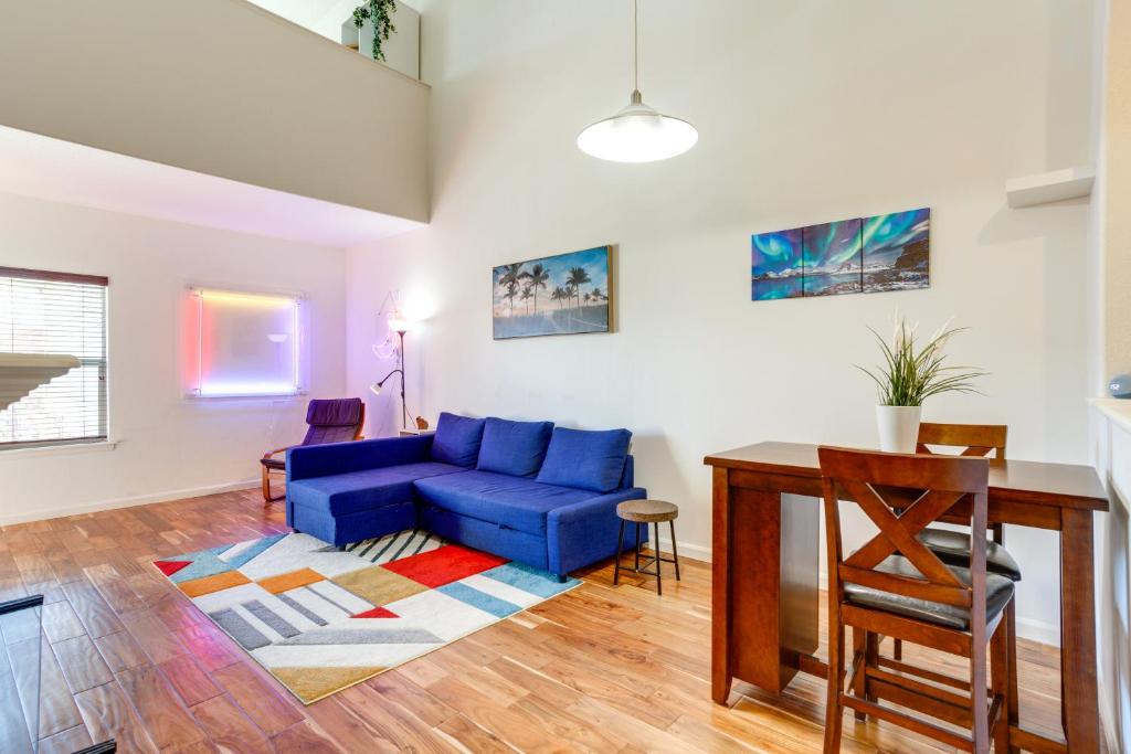 a living room with a blue couch and a table at 4 Mi to Airport Convenient Denver Condo in Aurora