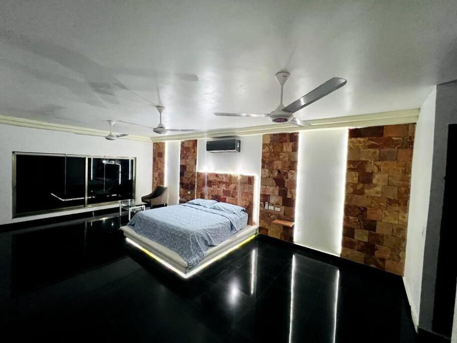 a bedroom with a bed and a ceiling fan at Casa en la playa in Ciudad del Carmen