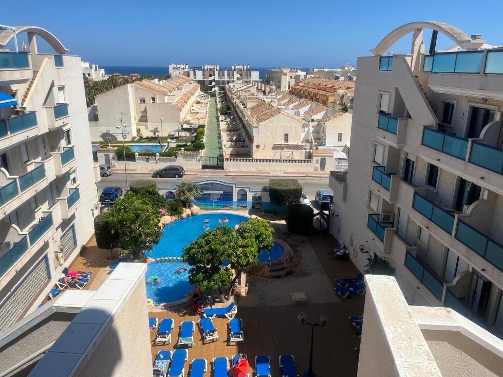 an aerial view of a resort with a swimming pool and buildings at Playamarina 2 Cabo Roig in Playas de Orihuela