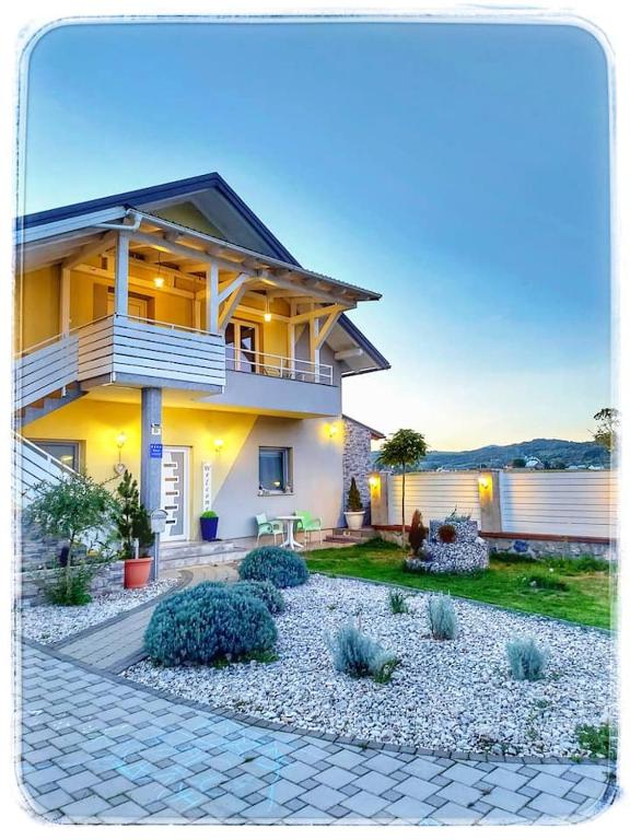 a house with a walkway in front of a yard at Ferienwohnung Luna mit Pool in Brinje