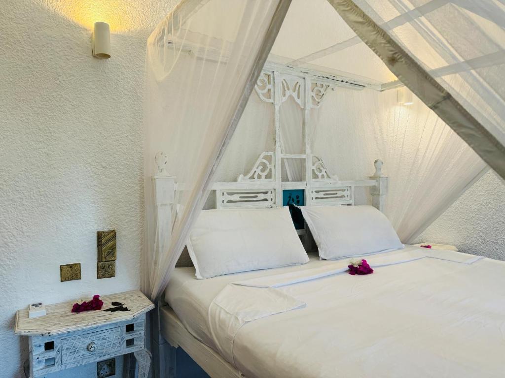 Postel nebo postele na pokoji v ubytování Watamu Villaggio