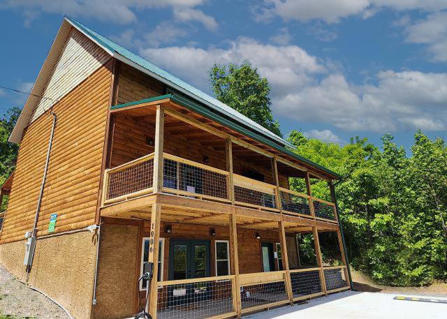 a large wooden house with a balcony on the front at Pooling Around #200 in Gatlinburg