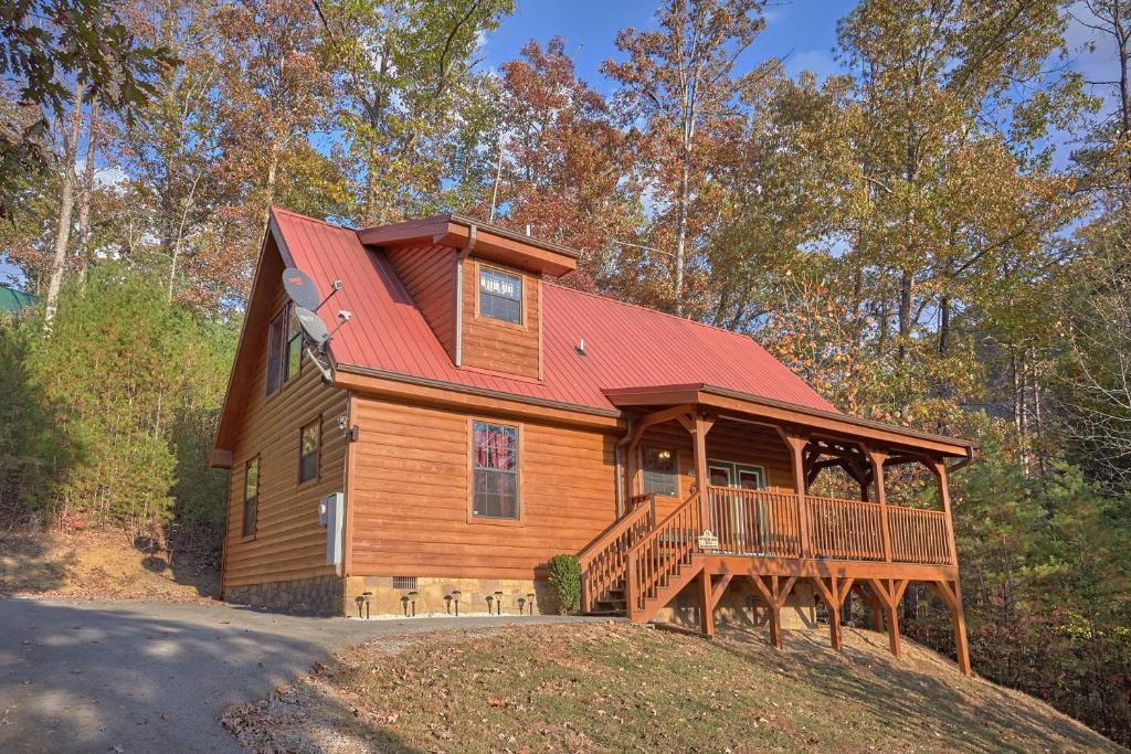 a large wooden house with a red roof at Wet Bear Paws #146 in Sevierville