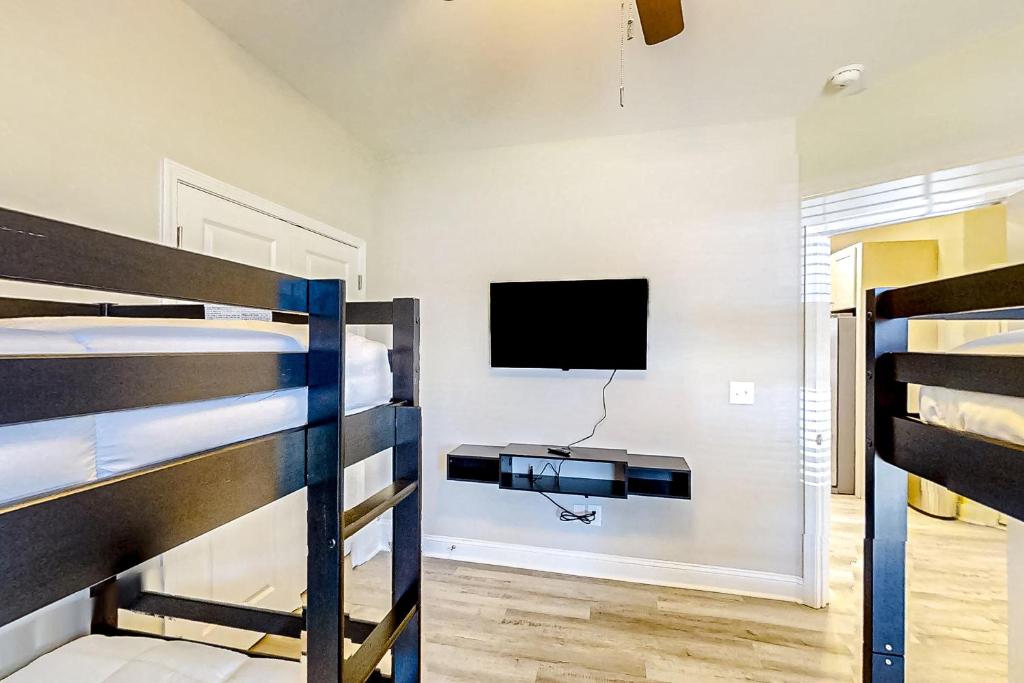 a bedroom with two bunk beds and a flat screen tv at Old Bryan Salento - A in Myrtle Beach