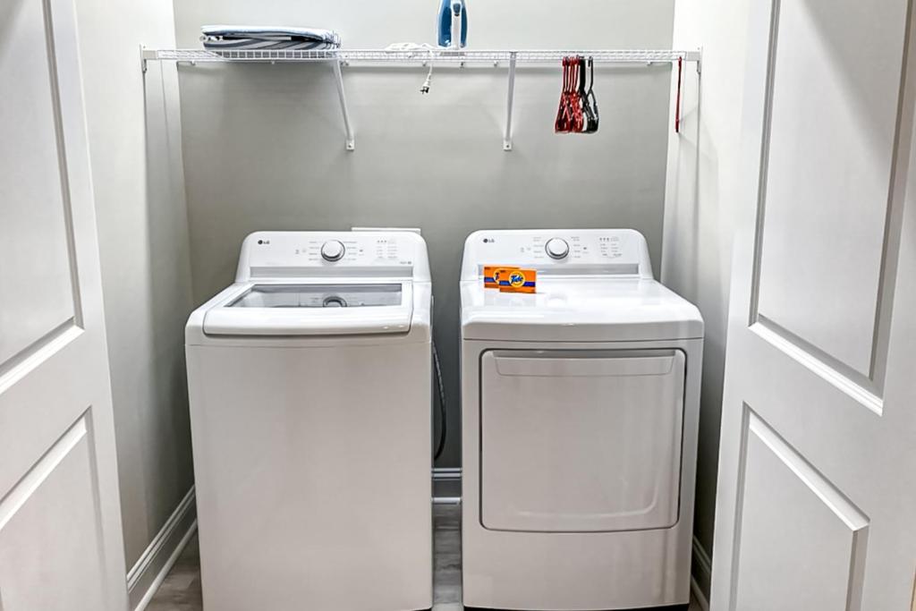 a small laundry room with a washer and dryer at Old Bryan Salento - A in Myrtle Beach