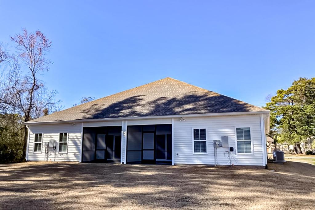 a white house with a large driveway at Old Bryan Salento - A in Myrtle Beach