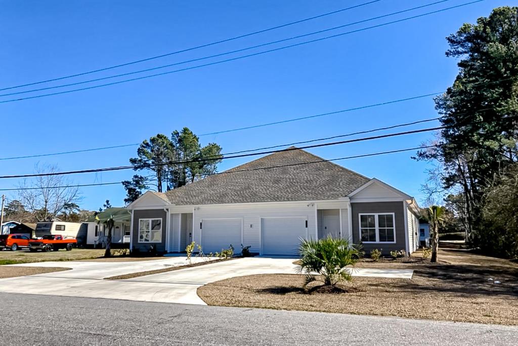 a small house with a garage on a street at Old Bryan Salento - A in Myrtle Beach