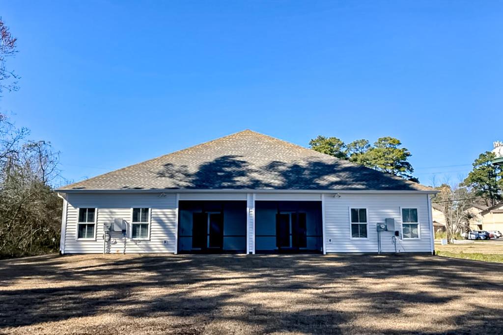 a white house with a large driveway at Old Bryan Salento - A in Myrtle Beach