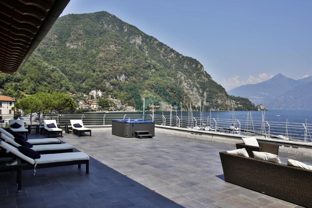 a patio with a view of the water and mountains at Villa Navalia in Menaggio