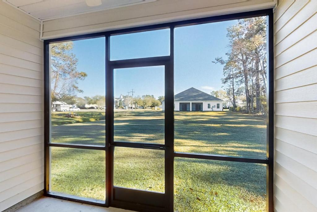 an open window with a view of a yard at Old Bryan Salento - B in Myrtle Beach
