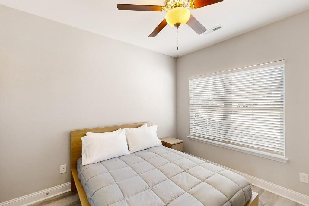 a bedroom with a ceiling fan and a bed at Old Bryan Salento - B in Myrtle Beach