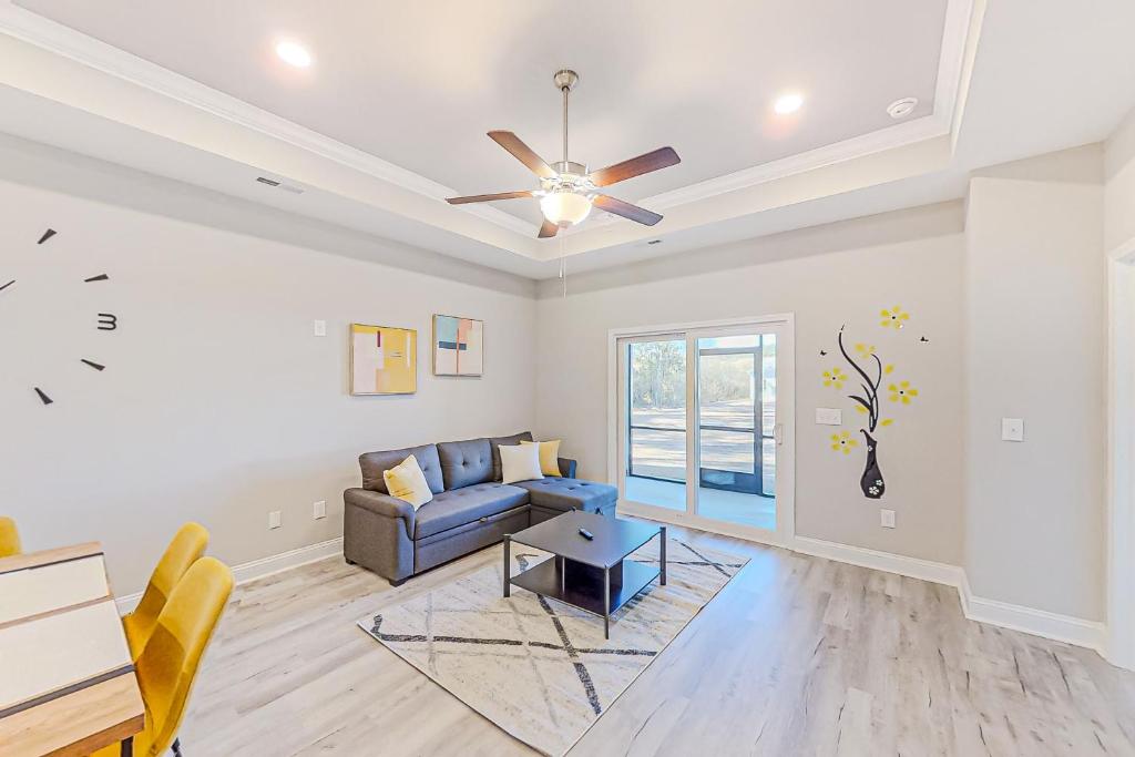 a living room with a couch and a ceiling fan at Cocora on Church Street - B in Myrtle Beach