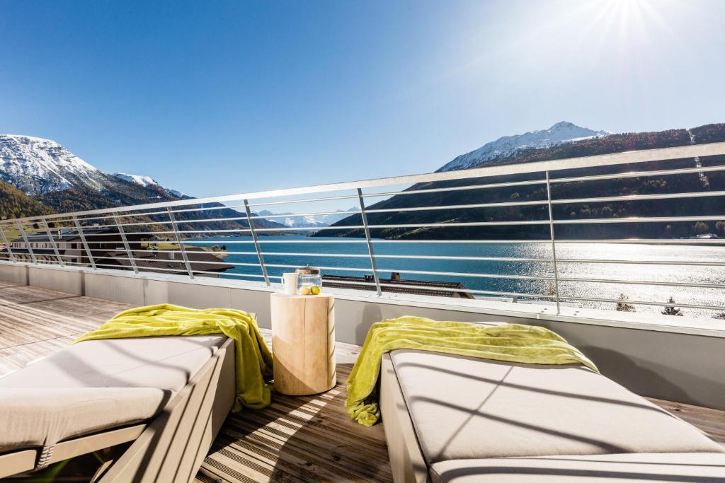 a balcony with two beds on a boat at Aktiv Hotel Edelweiss in Resia