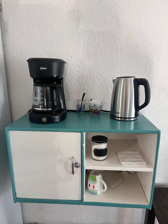 a blue shelf with a coffee maker on it at Nómadas Hostel in La Paz