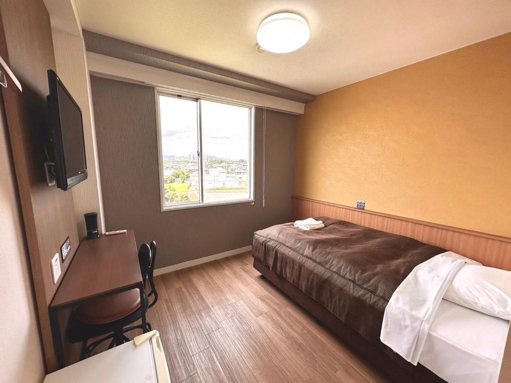 Postel nebo postele na pokoji v ubytování Tabist Tsukuba Sky Hotel