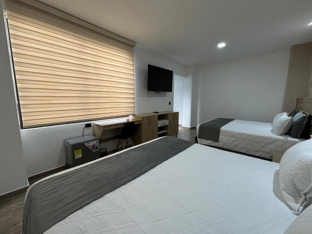 Postel nebo postele na pokoji v ubytování M A Hotel