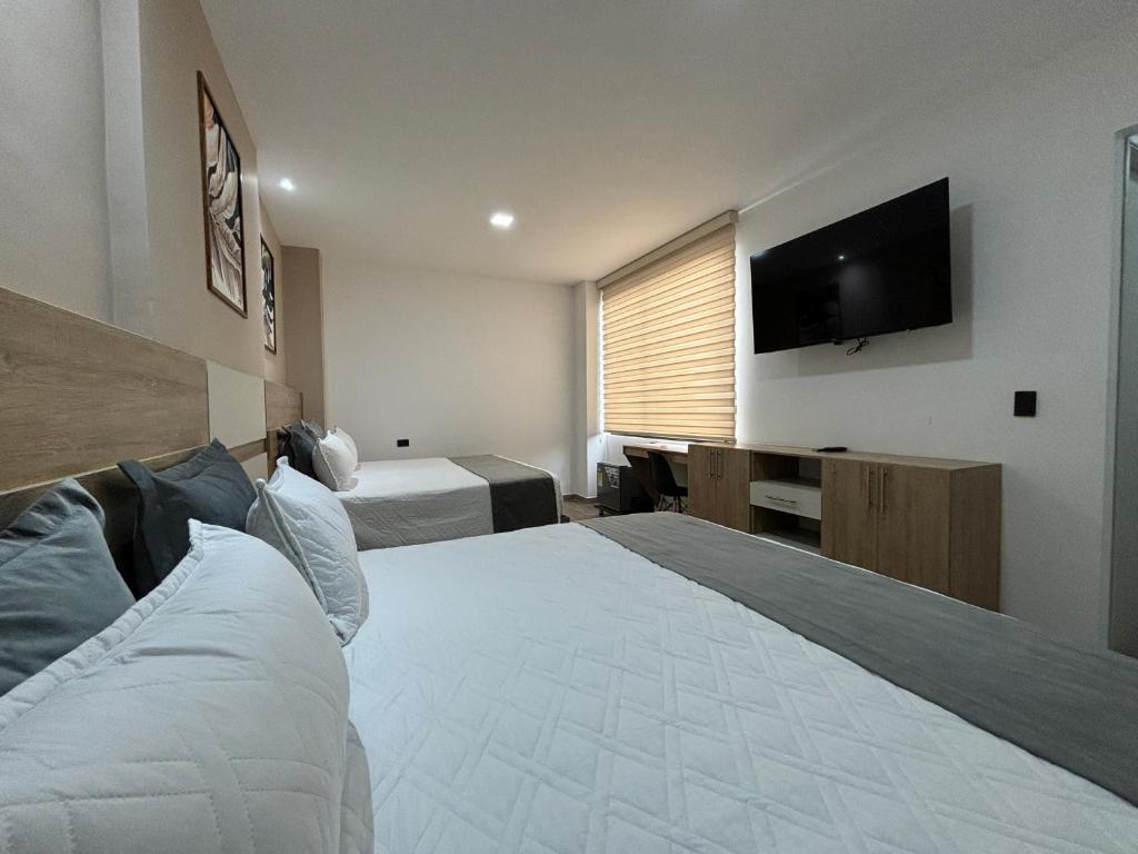Postel nebo postele na pokoji v ubytování M A Hotel