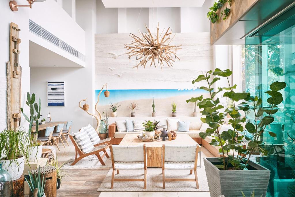 a living room with a table and chairs and a couch at Hayama Umino Hotel in Hayama