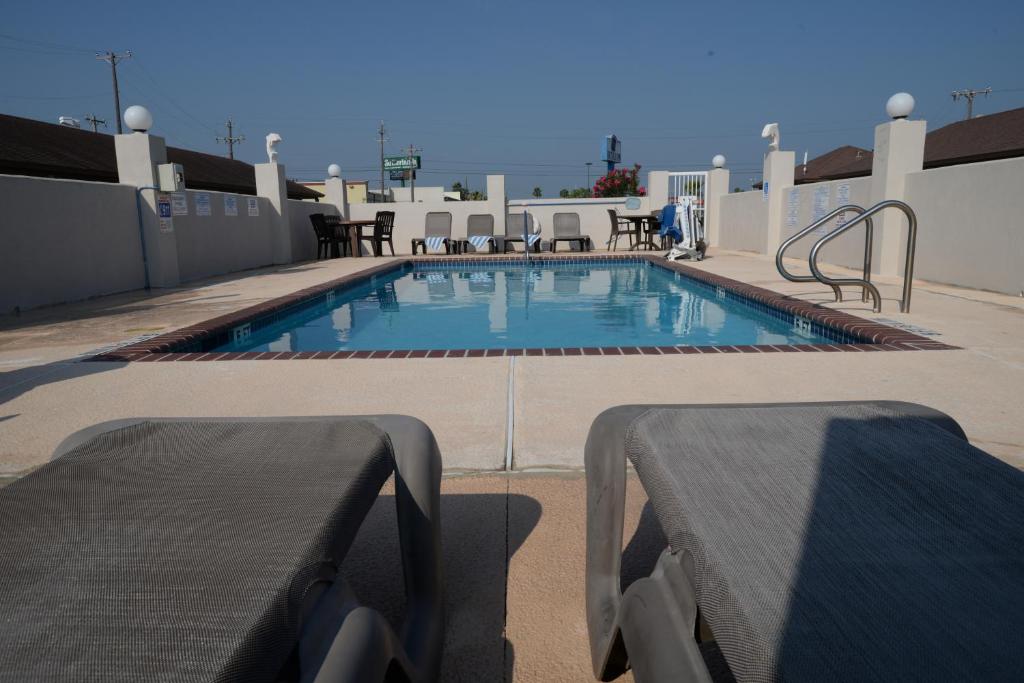 a swimming pool on the roof of a building at Port Isla Inn in Port Isabel