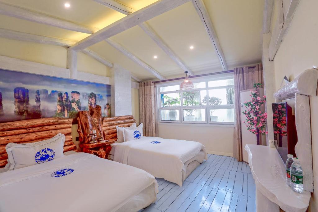 Postel nebo postele na pokoji v ubytování Zhoujia Hostel