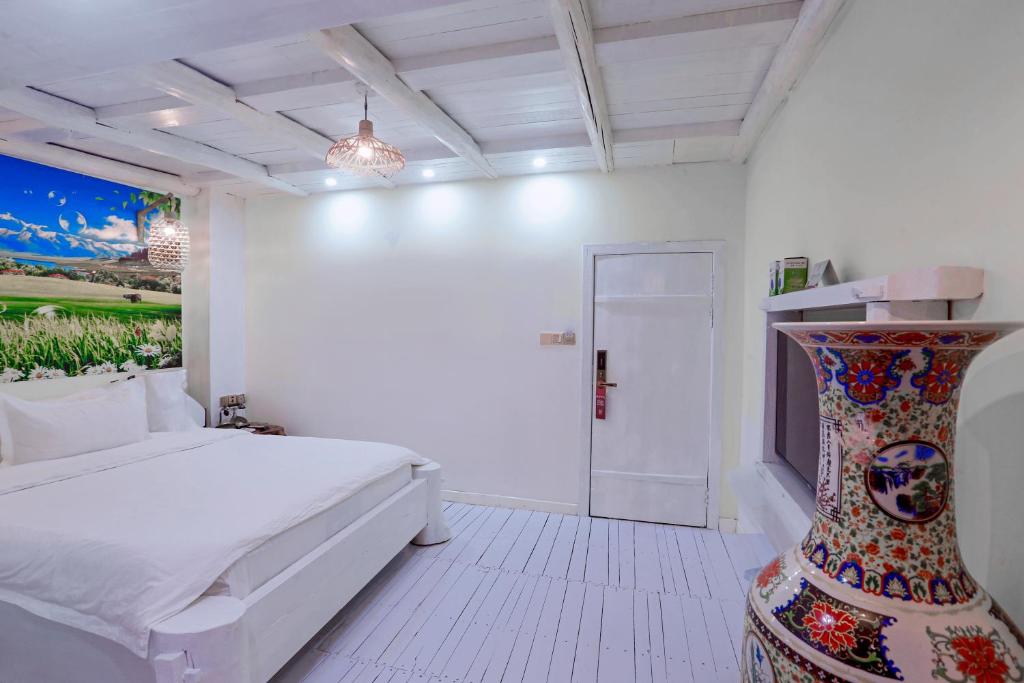 Postel nebo postele na pokoji v ubytování Zhoujia Hostel