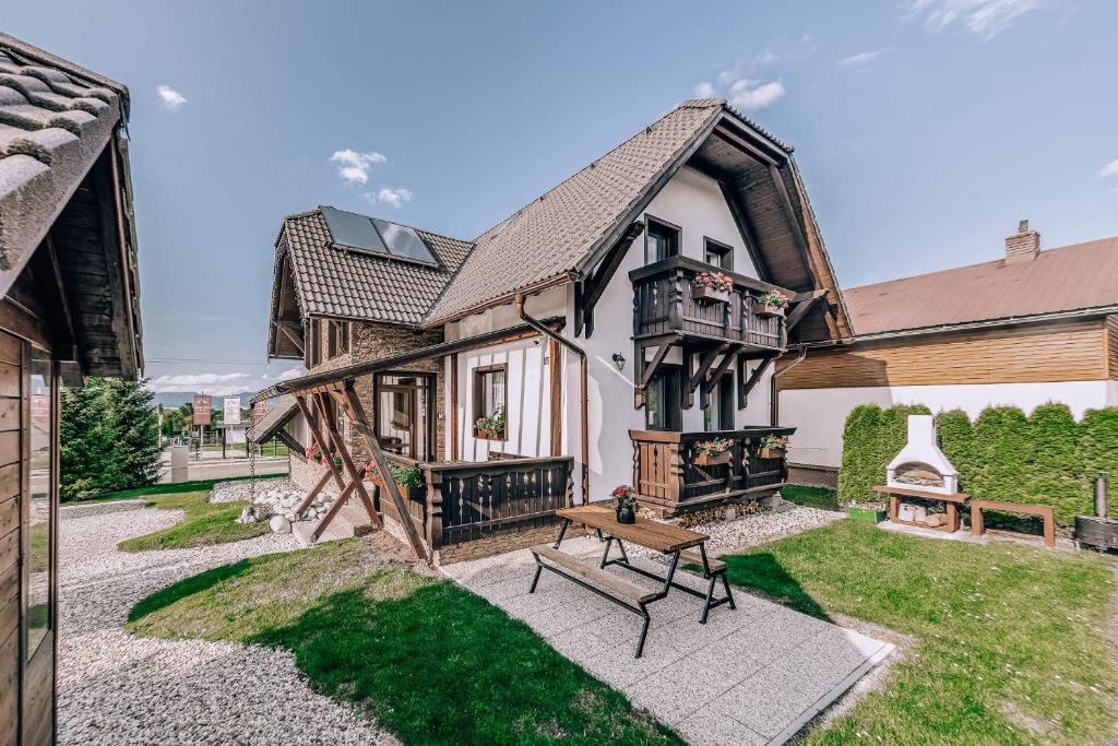 a house with a bench in the yard at Apartmány Pod Chopkom in Pavčina Lehota