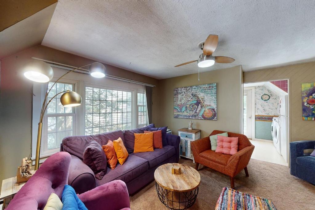 a living room with a purple couch and a table at Provincetown Bliss in Provincetown