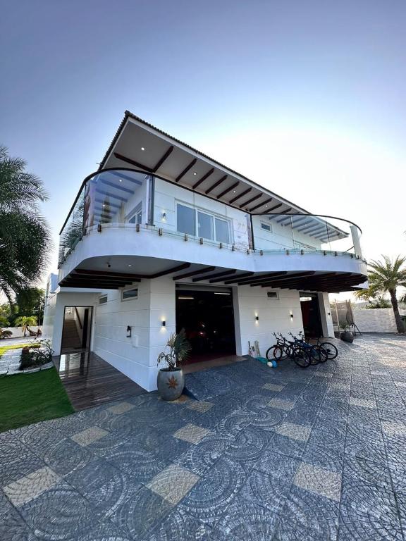 a building with a balcony on top of it at 154 Pearl Beach in Mahabalipuram