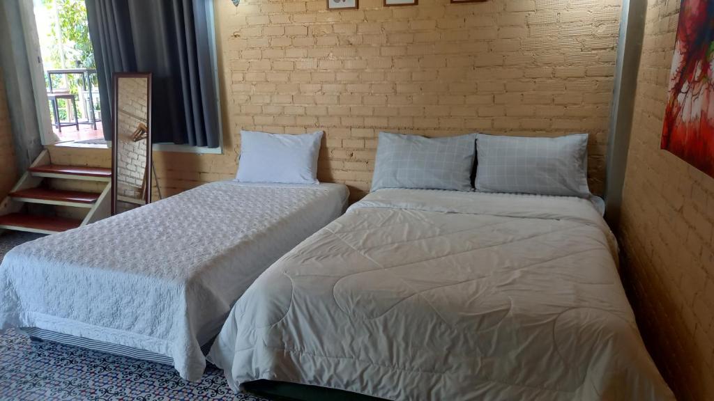 Postel nebo postele na pokoji v ubytování Bann Kam B&B