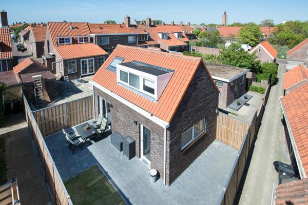 an overhead view of a house with an orange roof at Holiday Home D'arke in Westkapelle