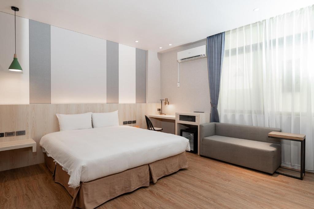 Postel nebo postele na pokoji v ubytování Fu Hsiang Hotel