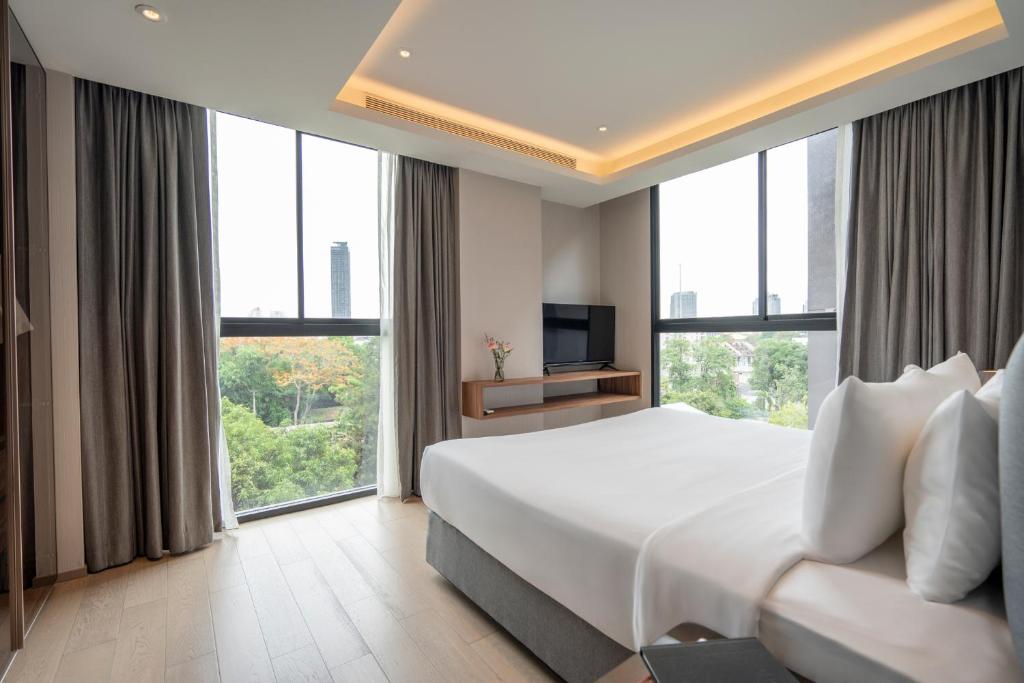 Postel nebo postele na pokoji v ubytování Walton Suites Sukhumvit