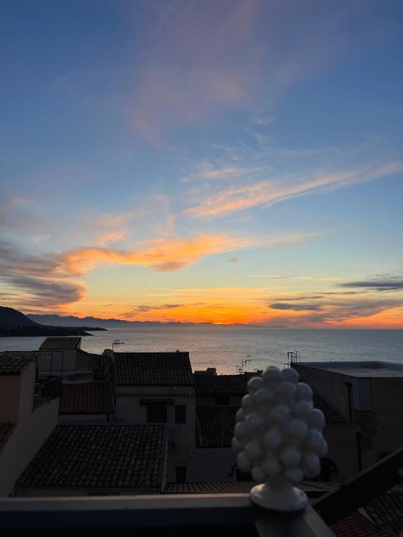 a view of the sunset from the roof of a building at Amori di Sicilia in Cefalù