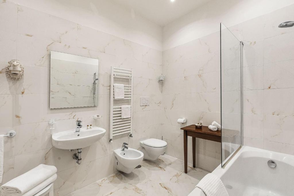 a white bathroom with a sink and a toilet at Hotel Marconi in Venice