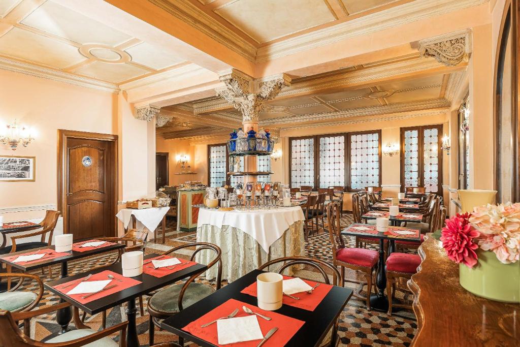 a restaurant with tables and chairs in a room at Hotel Marconi in Venice