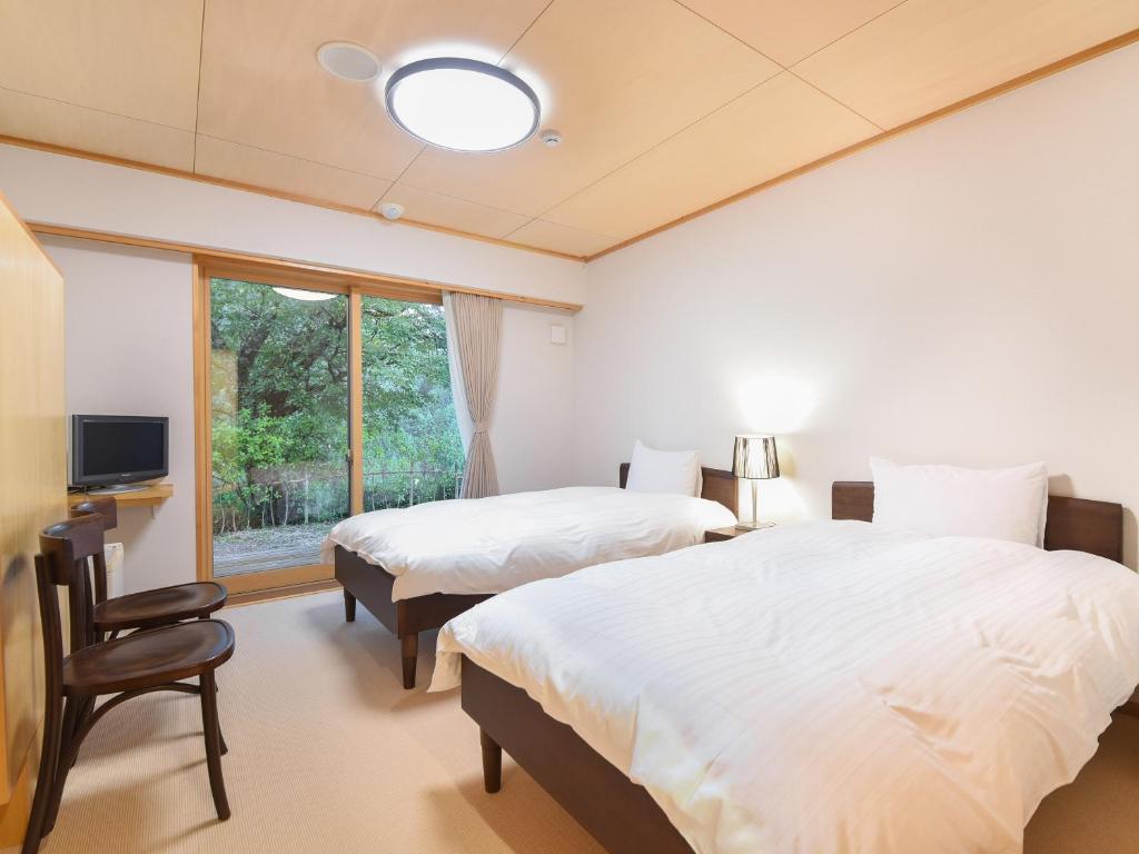 Postel nebo postele na pokoji v ubytování はなぞの温泉 花圃の里