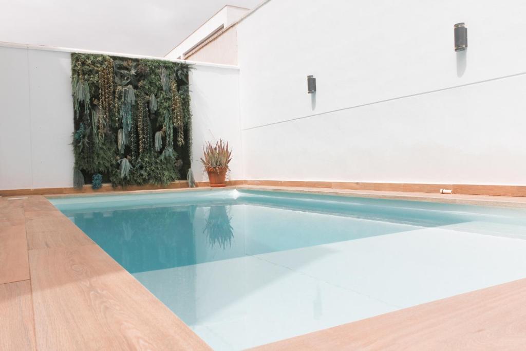 a large swimming pool in a white room with at Sunrise & Pool Mairena Metro in Mairena del Aljarafe