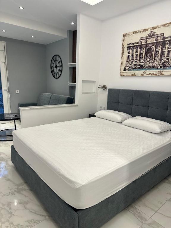 a bedroom with a large white bed in a room at Peraia Luxury Studio in Perea