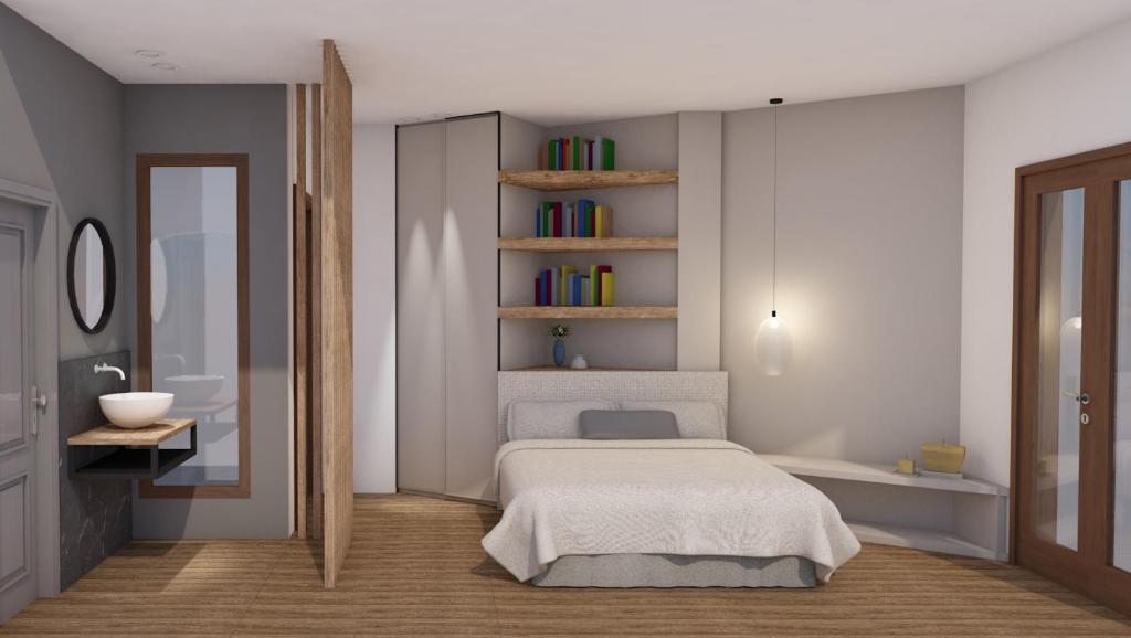 a bedroom with a white bed and a mirror at Athos Villas in Ouranoupoli