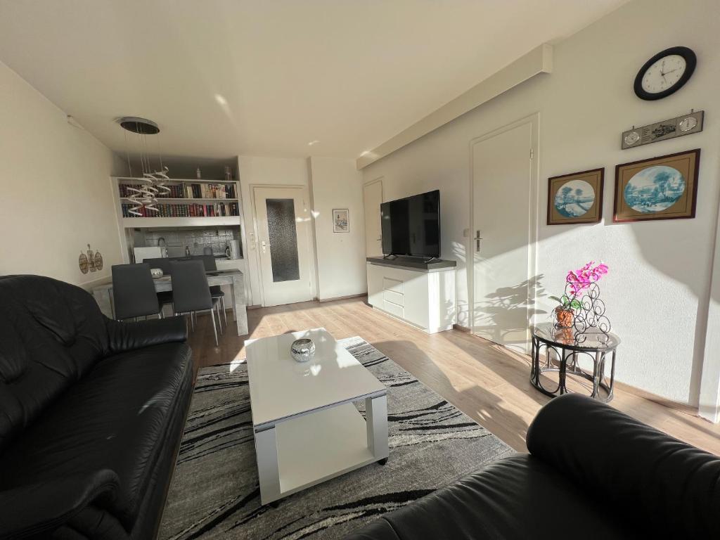 a living room with a couch and a table at Ferienwohnung Harz-Flair 264 in Hohegeiß