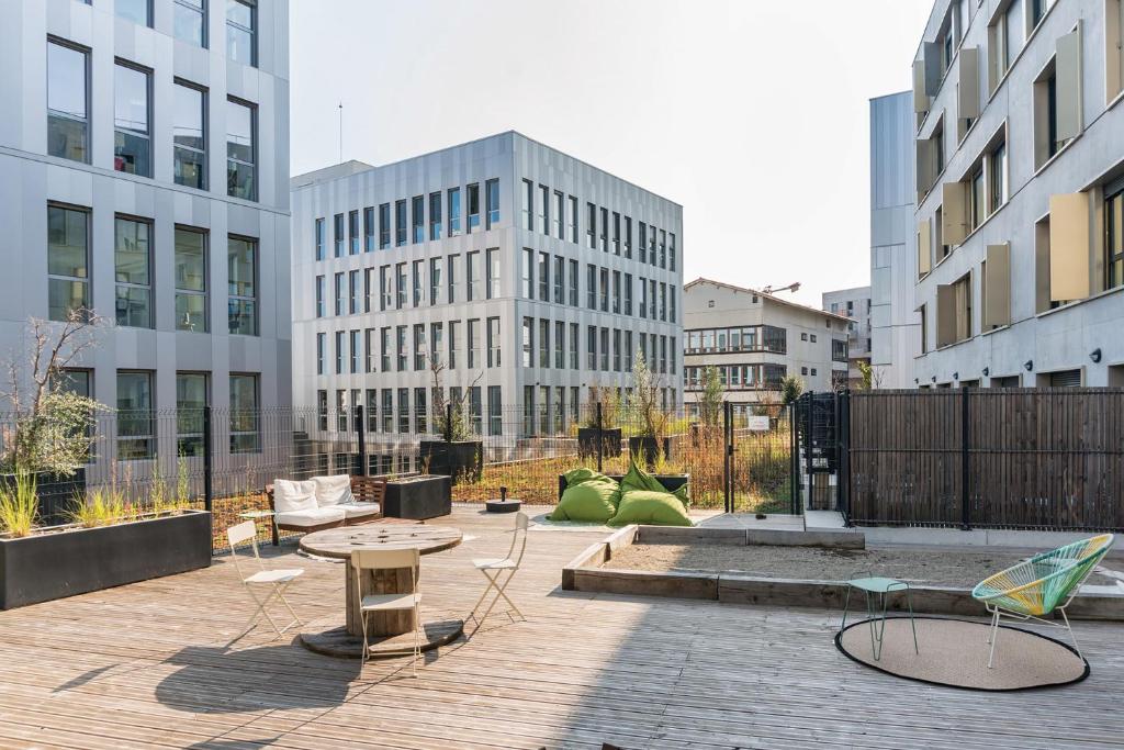 a patio with tables and chairs and buildings at Student Factory Bordeaux Armagnac in Bordeaux
