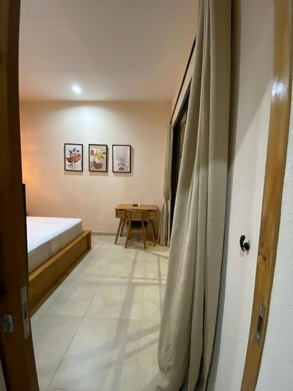 a room with a bed and a table in it at LM Home Mendira in Candidasa