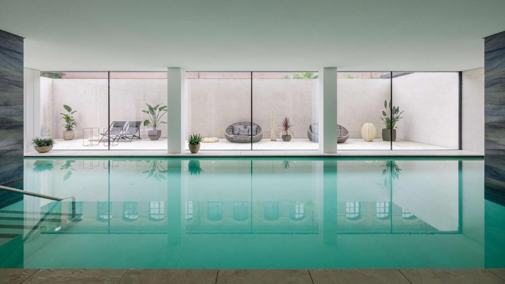 a swimming pool with blue water in a house at Hilton Lake Como in Como