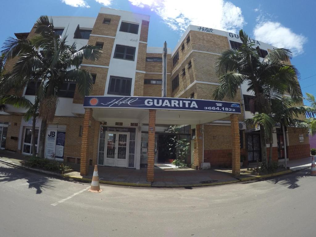 a building with a sign that reads quaterida at Hotel Guarita in Torres