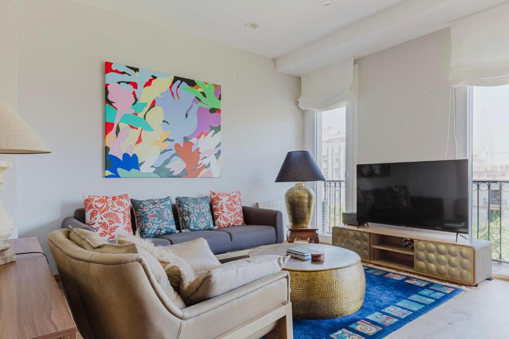a living room with a couch and a tv at Blueground La Dreta de lEixample elev washer BCN-150 in Barcelona